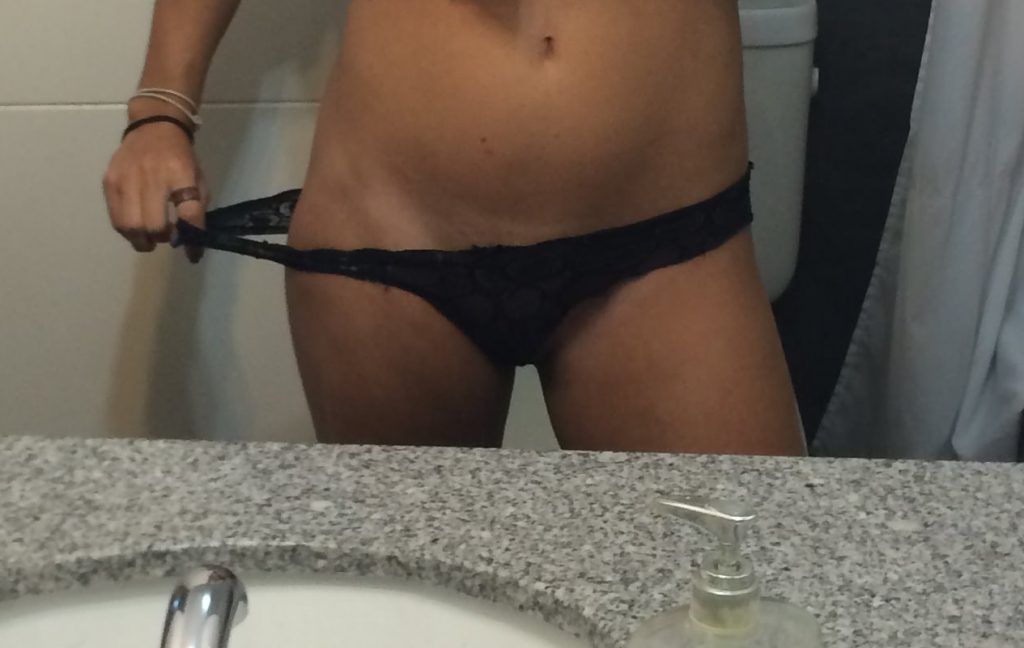 woman in underwear taking selfie in mirror