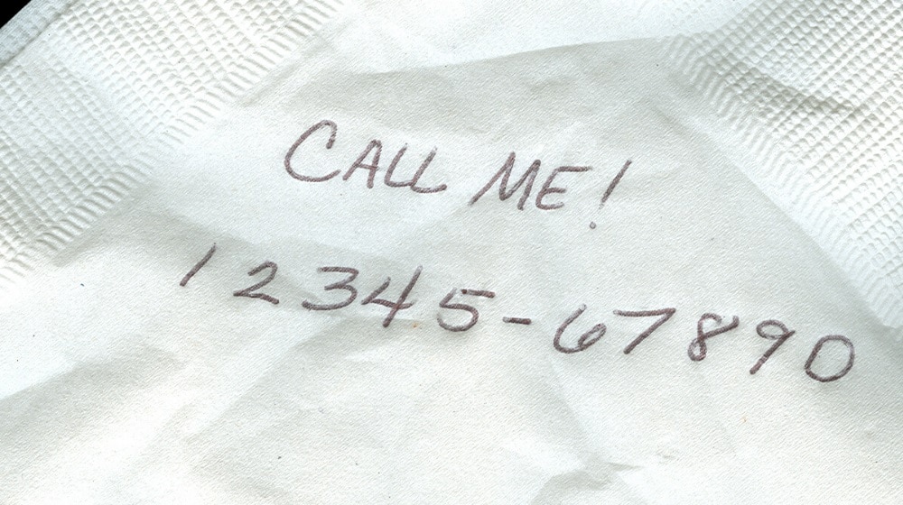 call me written on a piece of paper with a phone number